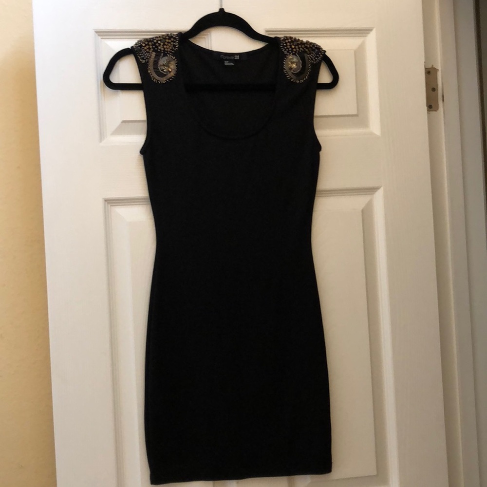 Black fitted dress with gold shoulder designs